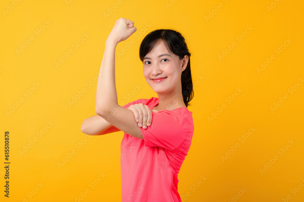 Portrait beautiful young asian sports fitness woman happy smile wearing pink sportswear posing exercise training workout isolated on yellow studio background. wellbeing and healthy lifestyle concept. Portrait beautiful young asian sports fitness woman happy smile wearing pink sportswear posing exercise training workout isolated on yellow studio background. wellbeing and healthy lifestyle concept.