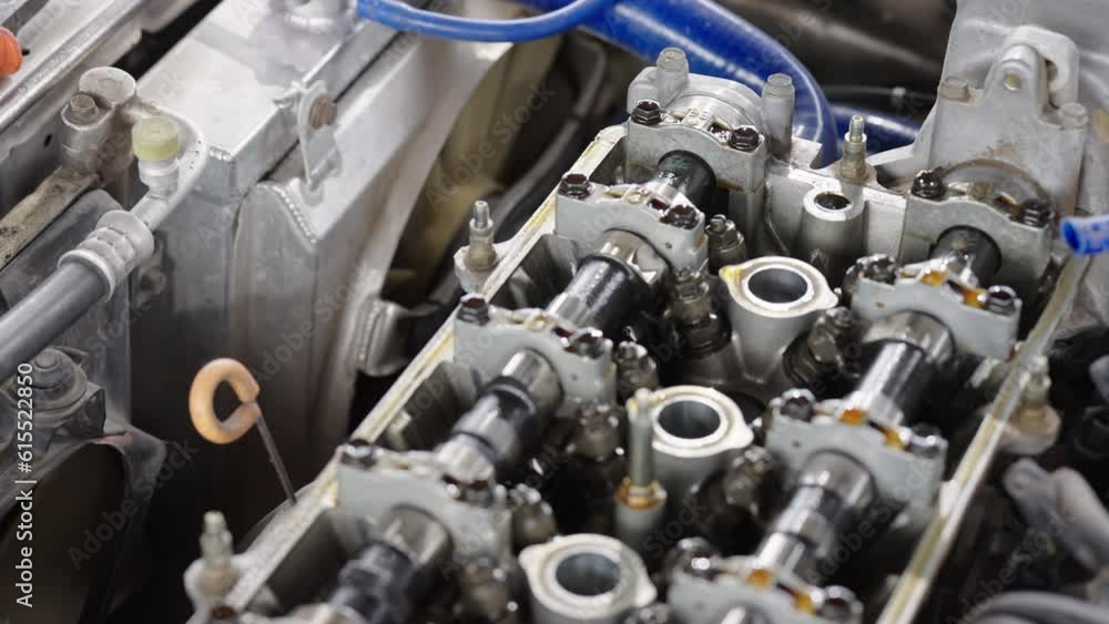 Auto mechanic repair engine in a car repair shop.Car engine repair. Car service Auto mechanic repair engine in a car repair shop.Car engine repair. Car service