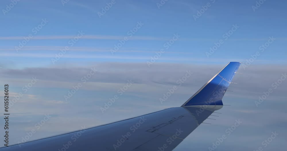 Window view during flight in wing of an aircraft with gorgeous blue sky background Window view during flight in wing of an aircraft with gorgeous blue sky background