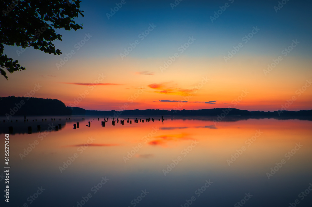 See im Abendrot - Sunset - Landscape - Beautiful Sunset scene over the lake and silhouette hills in the background - Sunrise over sea - Colorful - Reed - Clouds - Sky - Sundown - Sun