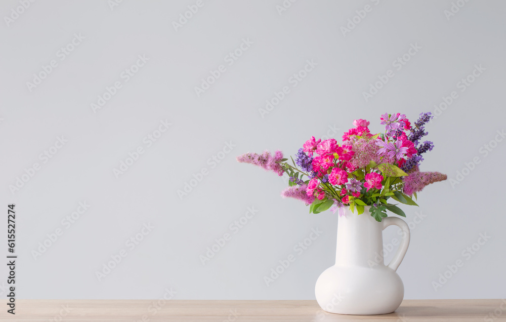beautiful flowers in white jug on wooden shelf beautiful flowers in white jug on wooden shelf