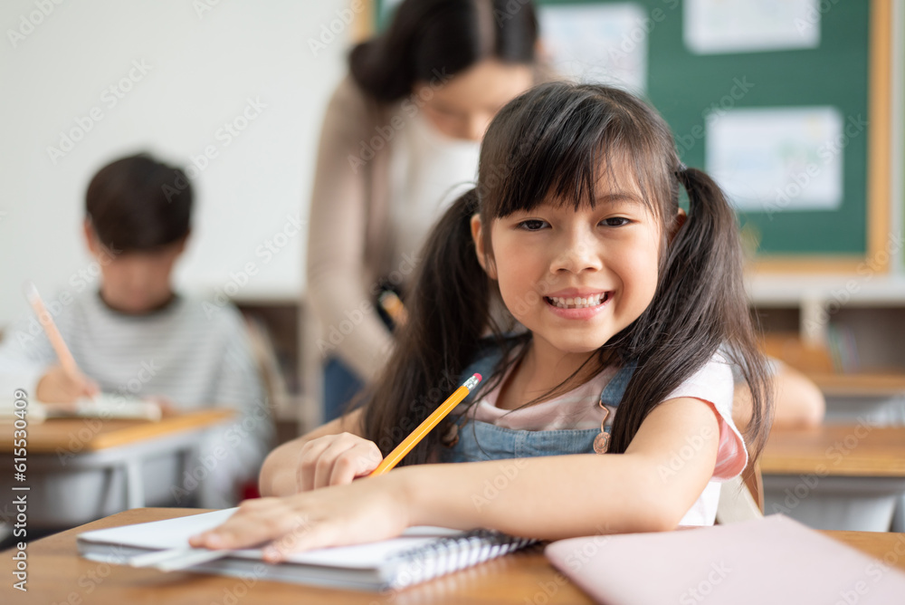 Portrait of Asian Chinese school girl with pigtails in classroom Portrait of Asian Chinese school girl with pigtails in classroom