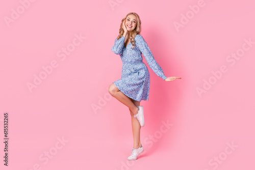 Full length portrait of satisfied glad young person stand one leg empty space ad isolated on pink color background