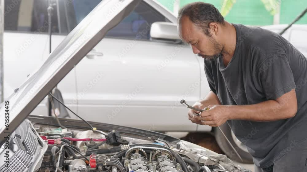 Auto mechanic repair engine in a car repair shop.Car engine repair. Car service Auto mechanic repair engine in a car repair shop.Car engine repair. Car service