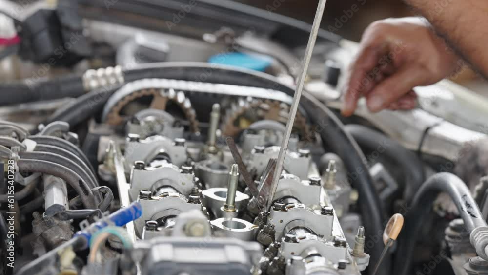 Auto mechanic repair engine in a car repair shop.Car engine repair. Car service Auto mechanic repair engine in a car repair shop.Car engine repair. Car service