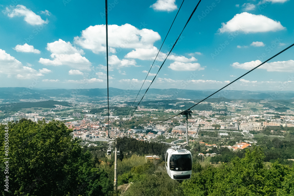 Guimaraes, Portugal. April 14, 2022: Panoramic of Guimaraes and cable car of the city with beautiful blue sky.