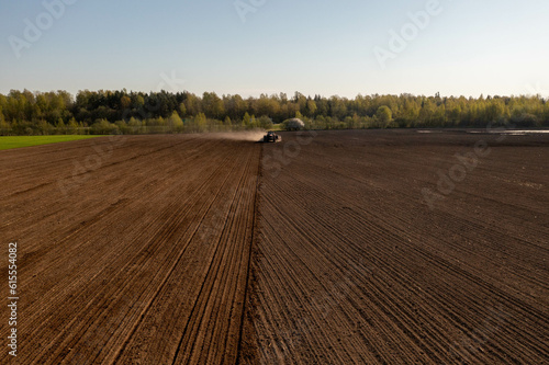 Drone photography of agricultural equipment working in field