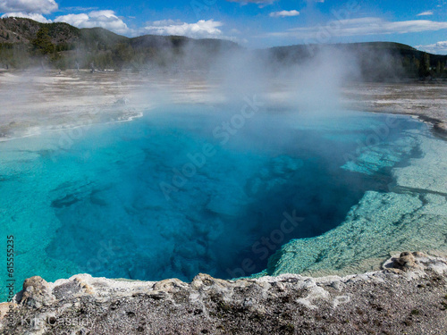 Grand Blue Prismatic Spring with steam rising in Yellowstone © Kris
