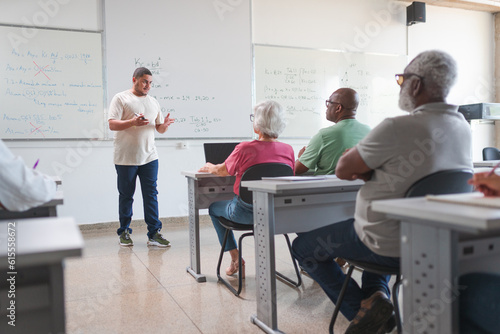 professor Brasileiro dando aula para uma turma de adultos e idosos em uma escola no Brasil photo