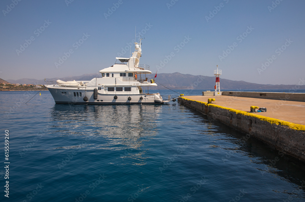 Yacht moored in the marina of Monemvasia island, Myrtoan Sea, Peloponnese, Laconia, Greece in summer sunny day. Yacht moored in the marina of Monemvasia island, Myrtoan Sea, Peloponnese, Laconia, Greece in summer sunny day.