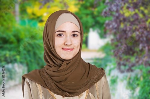 young happy muslim woman posing outdoors.