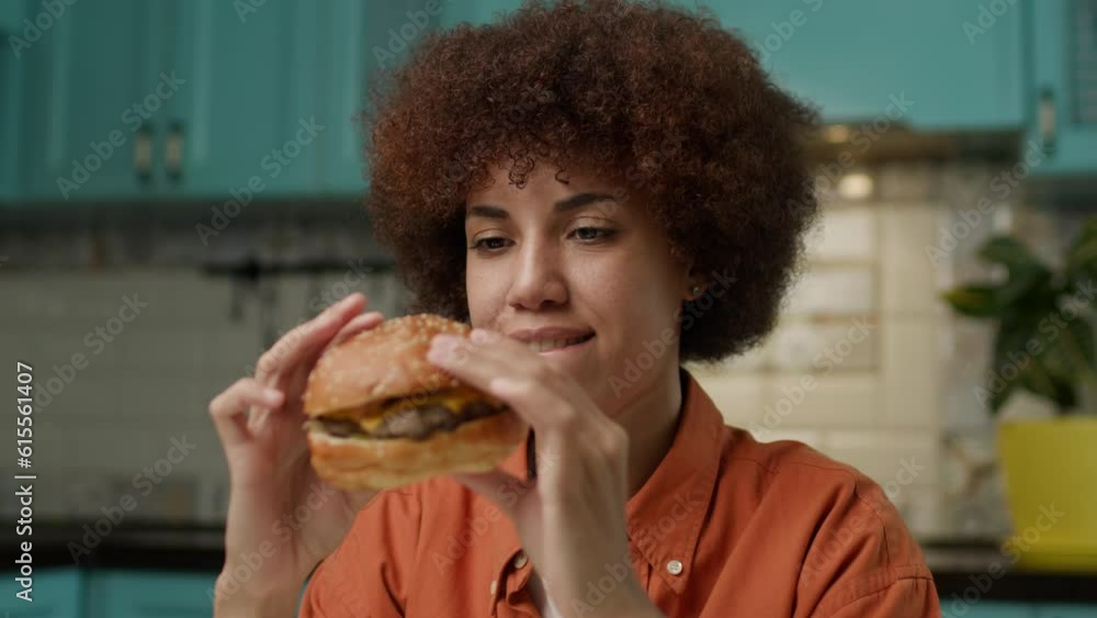 Black Woman holding Burger in Hands. Hungry African American female is ready to eat burger. Black Woman holding Burger in Hands. Hungry African American female is ready to eat burger.