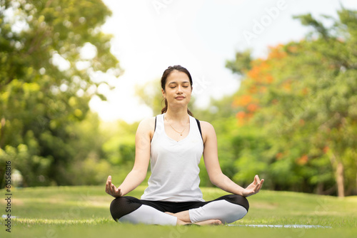 Woman Yoga - relax in nature. beauty woman doing yoga at park. woman practising yoga at park.. © Montri