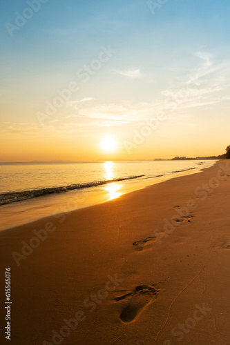 Fototapeta Naklejka Na Ścianę i Meble -  footprints in sand at beach with sunset