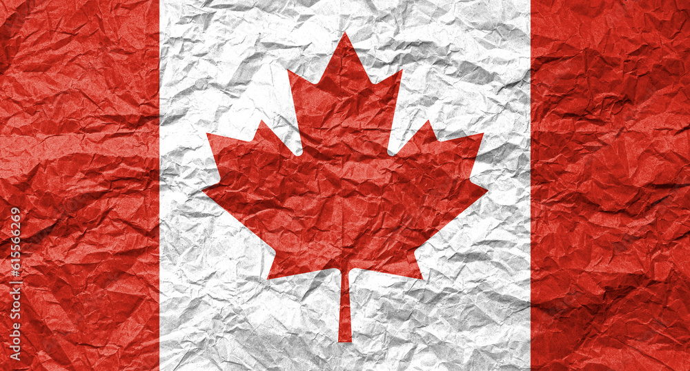 Flag of Canada on crumpled paper. Textured background.