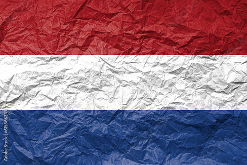 Flag of Netherland on crumpled paper. Textured background.