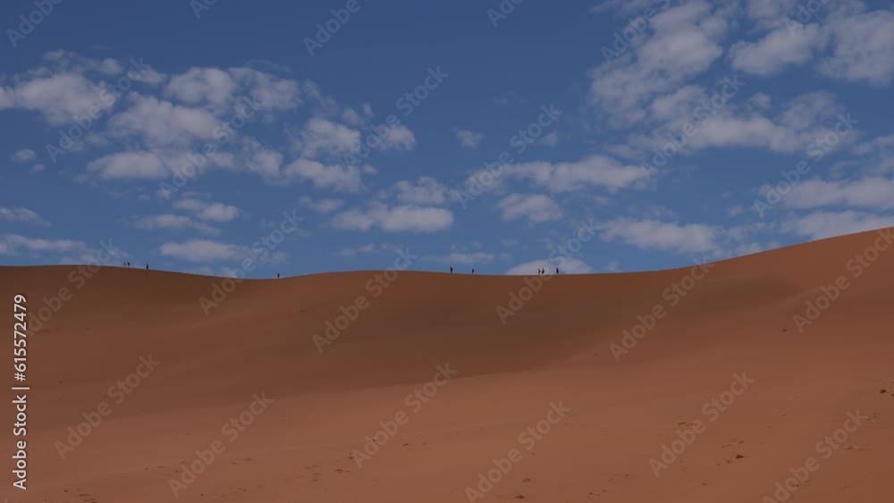 Orange desert with blue sky with small clouds. Red desert sand dunes in Sossusvlei or Sesriem in Namibia. Namib Desert and Big Daddy dune in Deadvlei. 4K Cinematic High quality footage. Orange desert with blue sky with small clouds. Red desert sand dunes in Sossusvlei or Sesriem in Namibia. Namib Desert and Big Daddy dune in Deadvlei. 4K Cinematic High quality footage.