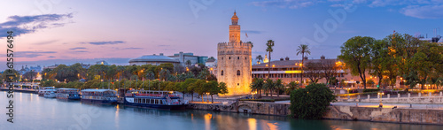 Sunset panorama over Seville, Guadalquivir river and golden tower Torre del Oro. photo