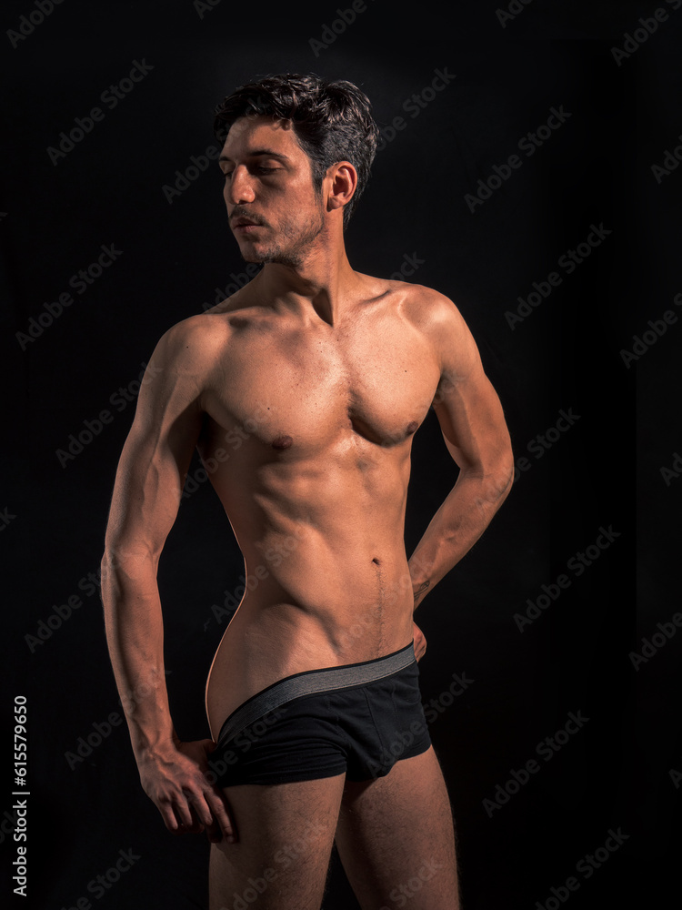 Muscular man pulling down underwear to show his butt