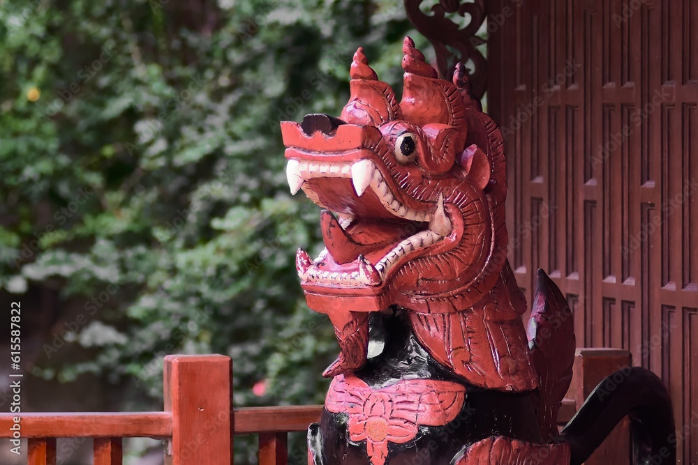 Dragon statue. The Buddhist temple is distinguished by its elaborate sculptures of vivid orange and black colors.