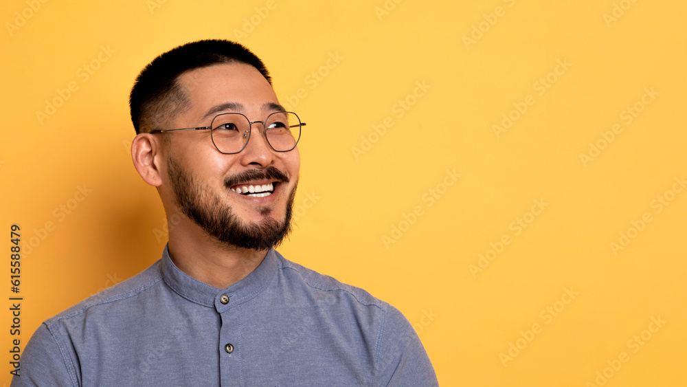Handsome Asian Man In Eyeglasses Looking Aside At Copy Space With Interest Handsome Asian Man In Eyeglasses Looking Aside At Copy Space With Interest