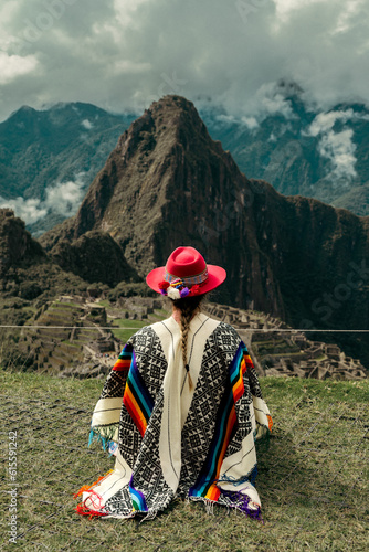 Tourist photography in Machu Picchu. Traveler with poncho and Inca hat. Wonder of the World. Colors	 photo
