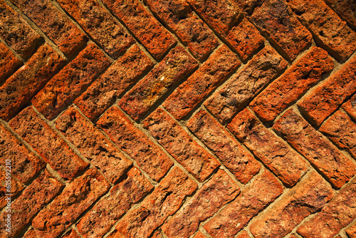 Diagonal pattern of an old red brick wall