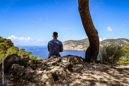 Young man enjoying the view of mountains and Mediterranean sea