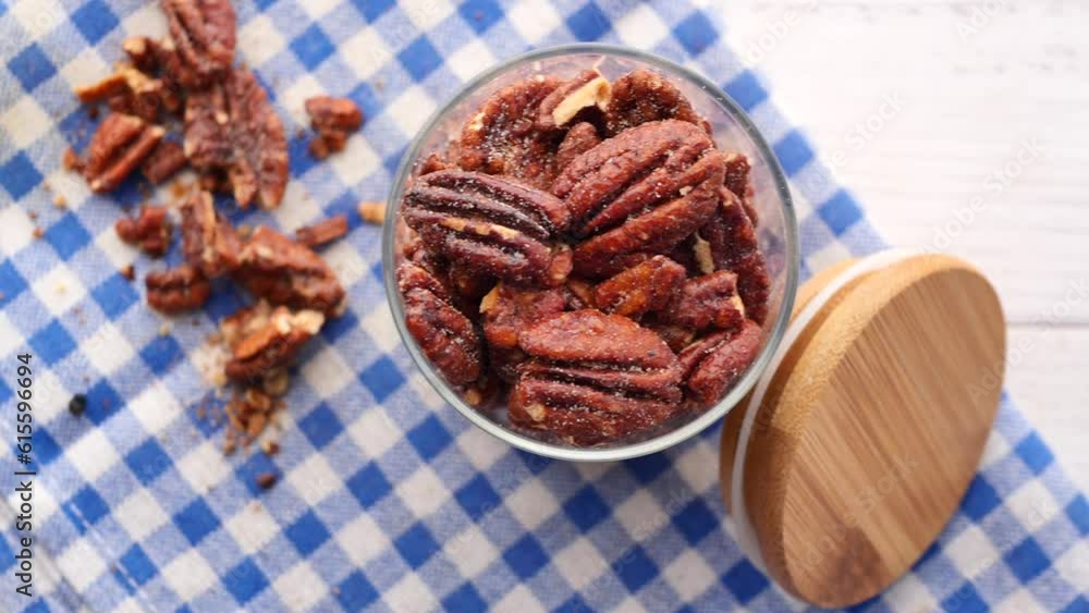 Tasty pecan nuts in a container on table Tasty pecan nuts in a container on table