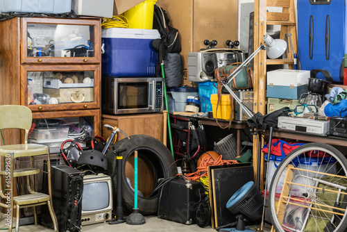 Messy clutter and household junk in the corner of a suburban garage.  