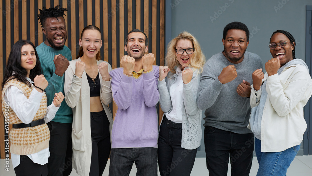 Group of business workers smiling happy. Standing with fists up at the office Group of business workers smiling happy. Standing with fists up at the office
