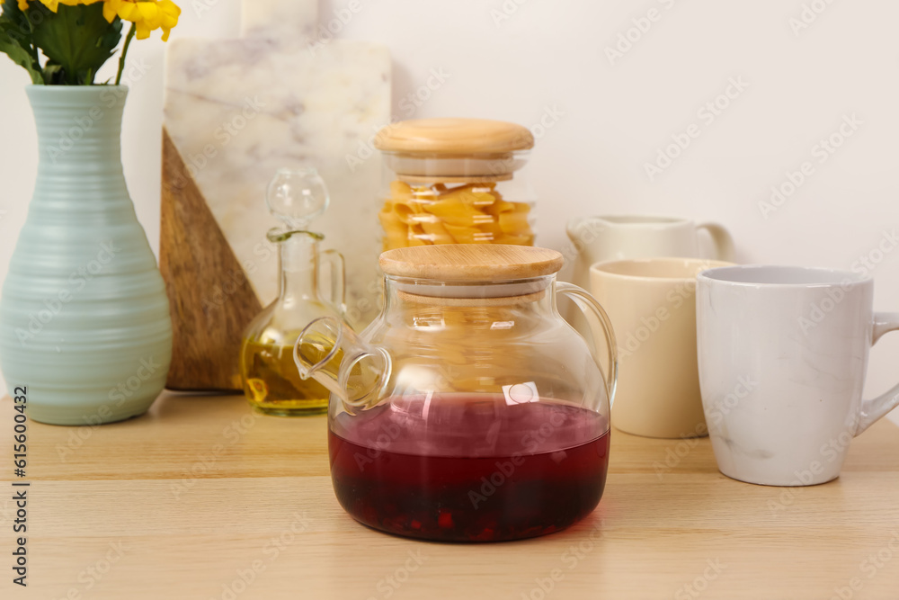 Teapot and different kitchen stuff on wooden table Teapot and different kitchen stuff on wooden table
