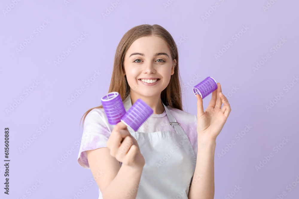 Female hairdresser with curlers on lilac background, closeup Female hairdresser with curlers on lilac background, closeup