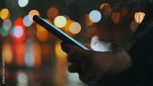 Woman's hands holding a phone, scrolling through the news feed with fingers