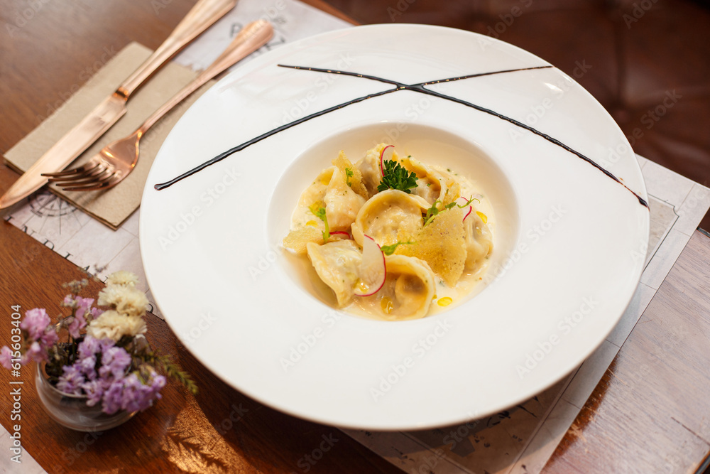ravioli stuffed with chicken in a white creamy sauce on restaurant table ravioli stuffed with chicken in a white creamy sauce on restaurant table