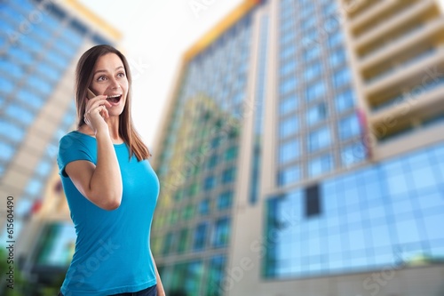 Young cheerful successful businesswoman talking on the phone. Free Download Young cheerful successful businesswoman talking on the phone. - GFXLoad