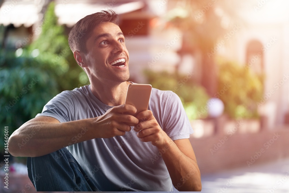Successful young businessman hold phone. Successful young businessman hold phone.