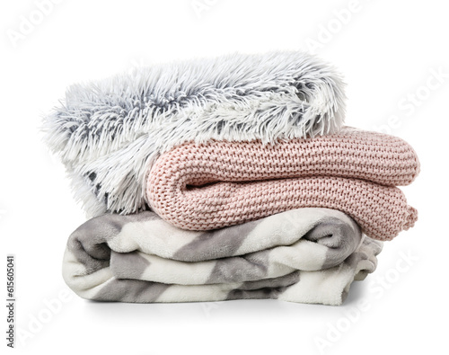 Different soft folded blankets on white background