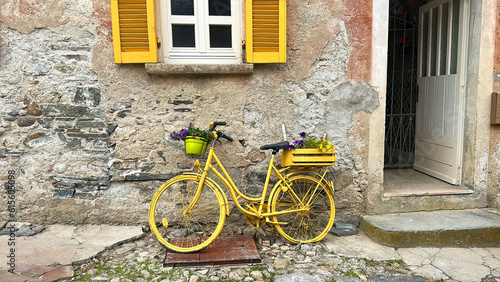 Old yellow decorated bike, used as house decoration.