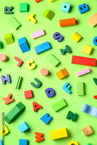 Wooden letters with colorful blocks on green background. Children's Day celebration