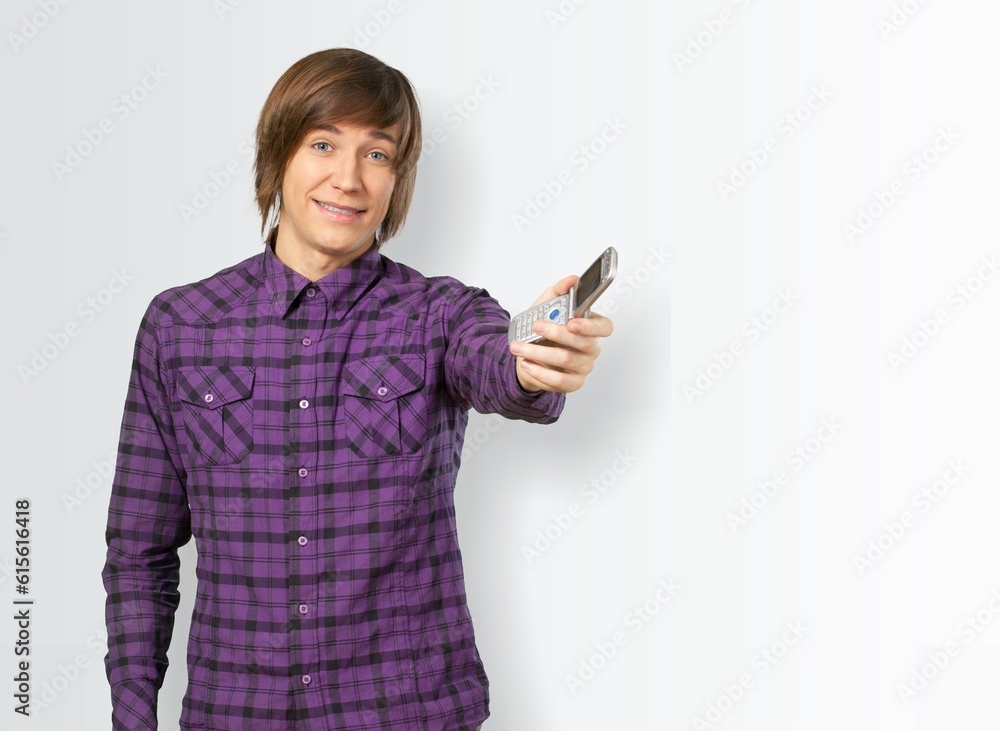 Confident positive young man with smartphone Confident positive young man with smartphone