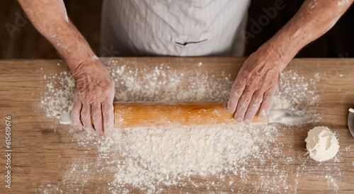 person kneading dough on the table in high definition
