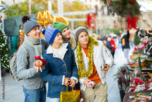 Happy parents with teenagers at street X-mas market