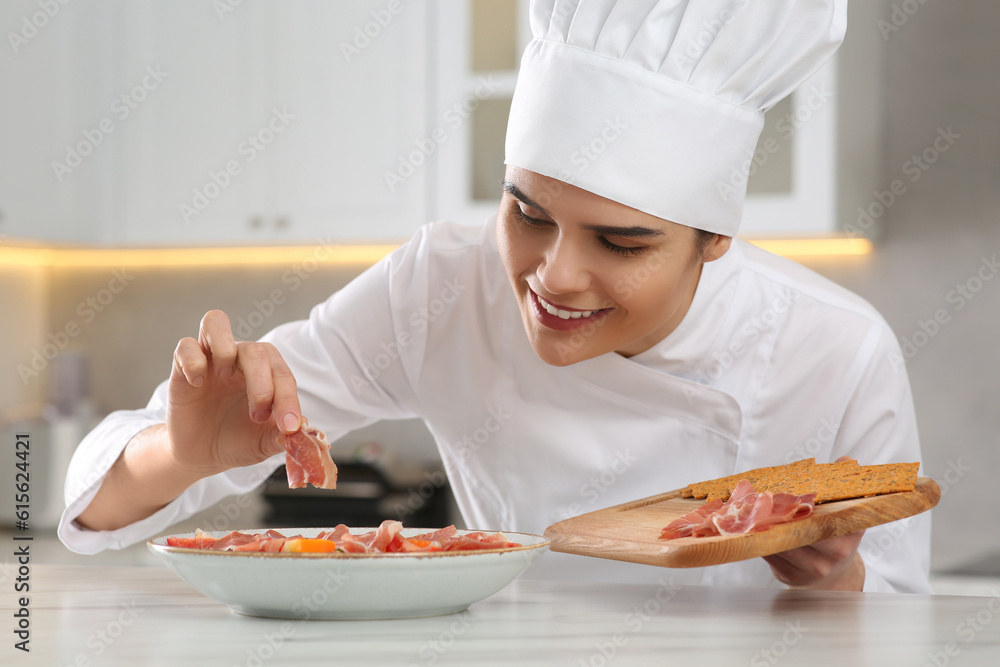 Professional chef adding prosciutto into delicious dish at white marble table in kitchen Professional chef adding prosciutto into delicious dish at white marble table in kitchen