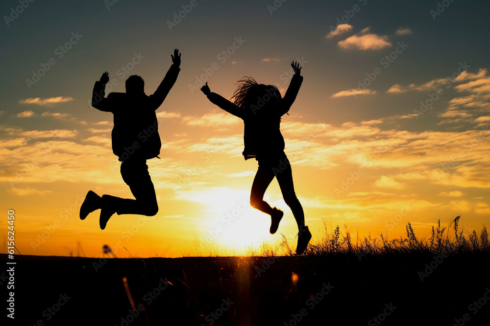 Silhouette of a group of happy people jumping at sunset for joy, copy space. Ai generated. Silhouette of a group of happy people jumping at sunset for joy, copy space. Ai generated.