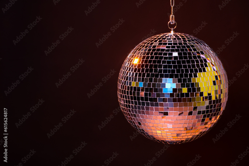 Obraz premium Shiny bright disco ball on dark background, space for text
