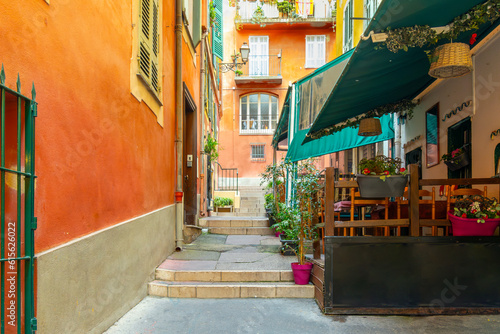 A small sidewalk cafe in a narrow alley staircase in the historic old town Vieux Nice, in the Mediterranean city of Nice, France, along the French Riviera.