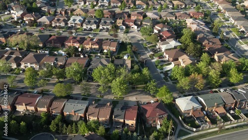 Aerial top down view of houses and streets in beautiful residential neighborhood in North America. Real estate, drone shots, sunset, sunlight. View from above on houses in Mississauga, Ontario Canada.