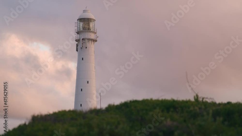 Close up uf Slangkop lighthouse in Kommetjie near Cape Town south Africa at sunset, white building photo