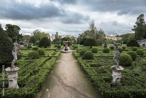 Park with decorative green bushes and maze on a cloudy day in Lisbon, Portugal